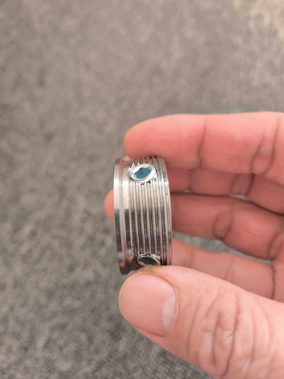 Side view of the socket adapter held between fingers