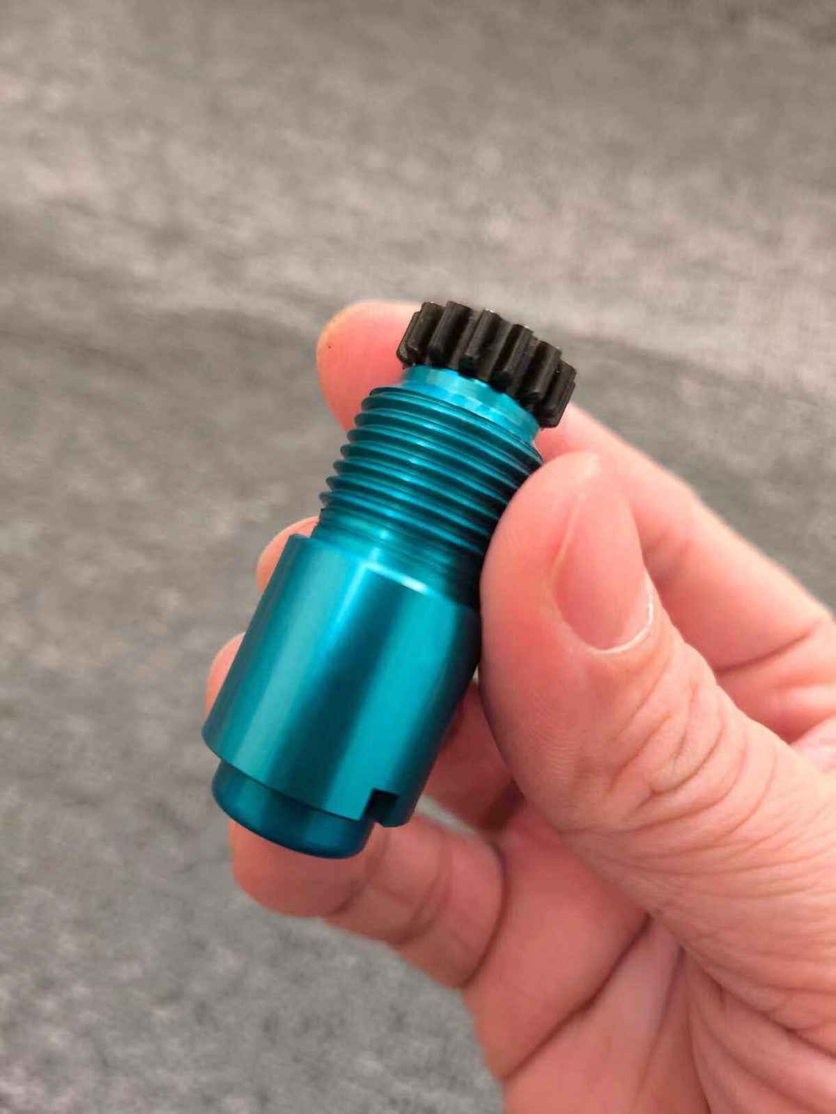 Prosthetic lock core held in a hand for scale