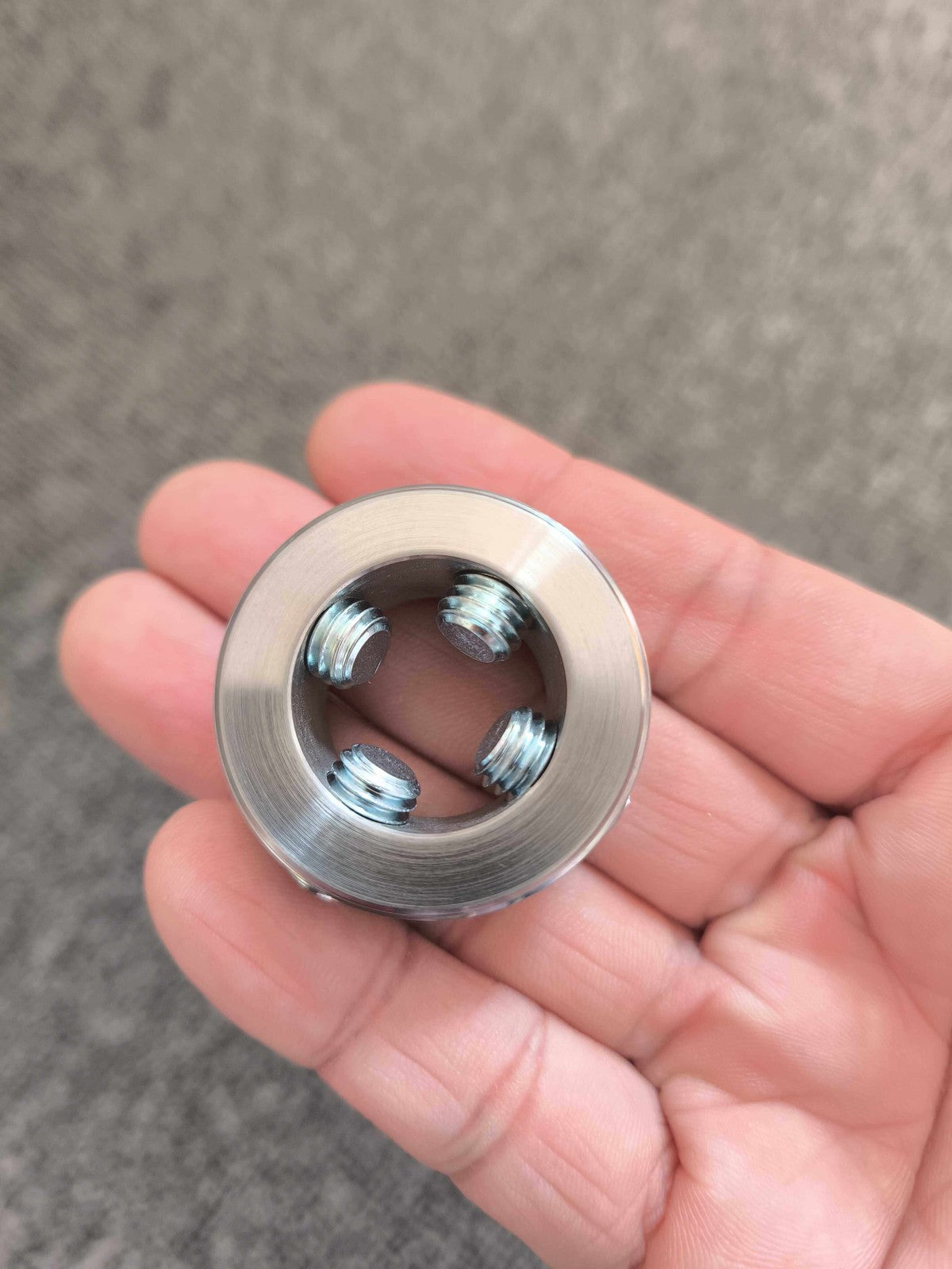 Prosthetic socket adapter held in a hand for scale